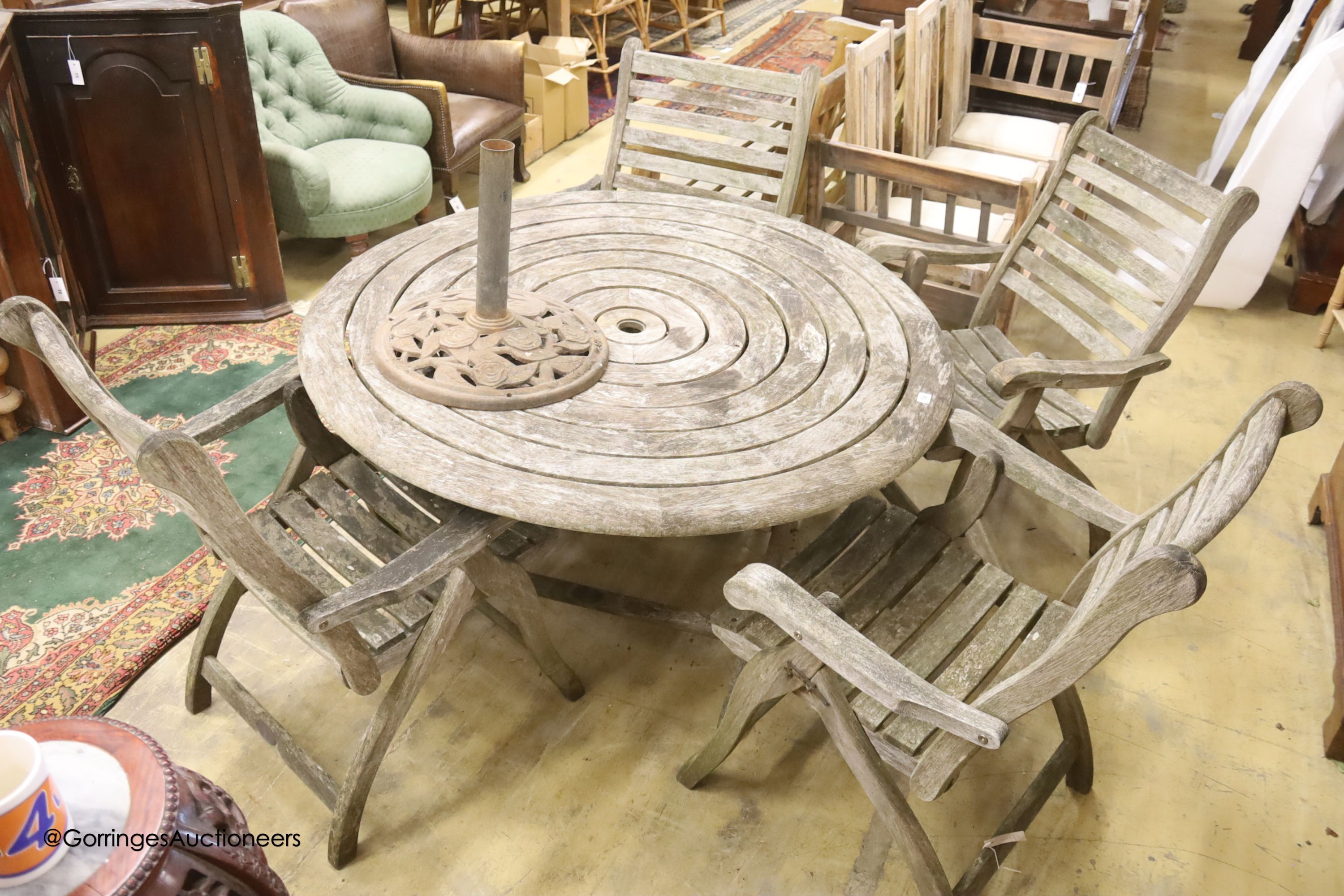 Alexander Rose weathered teak circular garden table, diameter 180cm, height 100cm and four folding elbow chairs